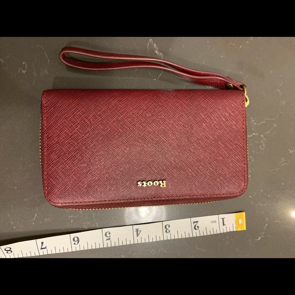 NWOT Roots maroon clutch wallet.